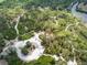 Birds-eye view captures the trails, parking area, and surrounding greenery at 2611 Eagle Crest Ct, Holiday, FL 34691