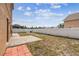 Large backyard area with concrete pavers and a white vinyl fence surrounding the yard at 2611 Eagle Crest Ct, Holiday, FL 34691
