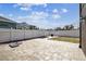 Paver patio with white fence surrounding the property and small yard at 2611 Eagle Crest Ct, Holiday, FL 34691