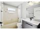 Bathroom featuring a shower and tub, a modern vanity, toilet, and neutral tile at 2611 Eagle Crest Ct, Holiday, FL 34691