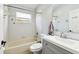 Bathroom with tub, shower, sink, vanity, and bright white subway tile at 2611 Eagle Crest Ct, Holiday, FL 34691