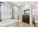 Bathroom with shower, bathtub, vanity, mirror, and natural stone floor at 2611 Eagle Crest Ct, Holiday, FL 34691