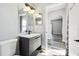 Well-lit bathroom featuring a modern vanity with dual mirrors and views into hallway at 2611 Eagle Crest Ct, Holiday, FL 34691