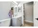 Bathroom with toilet, sink, vanity with grey cabinets and neutral paint at 2611 Eagle Crest Ct, Holiday, FL 34691