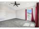 Upstairs bedroom with plush carpet, a ceiling fan, and a window overlooking the neighborhood at 2611 Eagle Crest Ct, Holiday, FL 34691