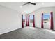 Bedroom with plush carpet, vaulted ceiling, three windows with beautiful views, and neutral decor at 2611 Eagle Crest Ct, Holiday, FL 34691
