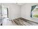 Empty bedroom showcasing a window, hardwood floors, and plenty of natural light at 2611 Eagle Crest Ct, Holiday, FL 34691