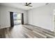 Bedroom with hardwood floors, a ceiling fan, and sliding glass doors to backyard at 2611 Eagle Crest Ct, Holiday, FL 34691
