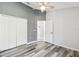 Bedroom with wood-look floors, closet, ceiling fan, and neutral paint at 2611 Eagle Crest Ct, Holiday, FL 34691