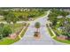 A beautifully landscaped community entrance featuring a palm tree island and decorative signage at 2611 Eagle Crest Ct, Holiday, FL 34691