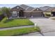Beautiful home with a three-car garage and a well-manicured lawn at 2611 Eagle Crest Ct, Holiday, FL 34691