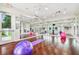 Bright fitness studio equipped with mirrors, yoga mats, exercise balls and hardwood floors at 2611 Eagle Crest Ct, Holiday, FL 34691