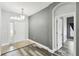 Inviting foyer featuring hardwood floors, neutral walls, and stylish light fixture at 2611 Eagle Crest Ct, Holiday, FL 34691