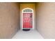 Welcoming front door showcasing red door and stylish exterior for a great curb appeal at 2611 Eagle Crest Ct, Holiday, FL 34691