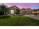 Charming one-story home featuring a well-manicured lawn, a two car garage and an inviting entryway at 2611 Eagle Crest Ct, Holiday, FL 34691