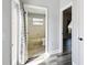 Hallway view into a bathroom with a shower and toilet and bedroom on the right at 2611 Eagle Crest Ct, Holiday, FL 34691