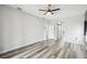Hallway with hardwood floors, arched doorways, and storage closets at 2611 Eagle Crest Ct, Holiday, FL 34691