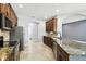 Modern kitchen featuring stainless steel appliances, granite countertops, and tiled floors at 2611 Eagle Crest Ct, Holiday, FL 34691