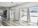 Inviting living area with wood floors and sliding glass doors leading to outdoor spaces at 2611 Eagle Crest Ct, Holiday, FL 34691