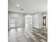 Bright living room with hardwood floors and an open floor plan leading to the kitchen at 2611 Eagle Crest Ct, Holiday, FL 34691