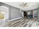 Spacious living room featuring wood floors, an arched doorway, and seamlessly connected to kitchen at 2611 Eagle Crest Ct, Holiday, FL 34691