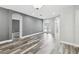 Spacious living room featuring hardwood floors, neutral gray walls, and arched doorways at 2611 Eagle Crest Ct, Holiday, FL 34691