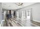 Open-concept living space with wood floors, access to the kitchen, and sliding glass doors to the backyard at 2611 Eagle Crest Ct, Holiday, FL 34691