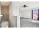 Bright loft space with plush carpet, a ceiling fan, and a window overlooking the neighborhood at 2611 Eagle Crest Ct, Holiday, FL 34691