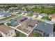 Aerial view of a neighborhood featuring homes with fenced yards, screened-in pools, and solar panels at 2611 Eagle Crest Ct, Holiday, FL 34691