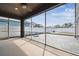 Screened-in patio featuring a ceiling fan and a paved patio area with a white fence at 2611 Eagle Crest Ct, Holiday, FL 34691