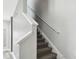 Carpeted staircase with white railing and trim inside a well-lit home at 2611 Eagle Crest Ct, Holiday, FL 34691