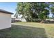 The backyard shows a green lawn, landscaping, and fencing at 26377 Bertram Rd, Brooksville, FL 34602