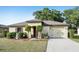 Charming single-story home featuring a well-manicured lawn and tidy landscaping at 26377 Bertram Rd, Brooksville, FL 34602