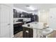 Modern kitchen with white countertops, dark cabinets and stainless-steel appliances at 26377 Bertram Rd, Brooksville, FL 34602