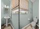 Charming half bathroom featuring stylish fixtures, including a pedestal sink and toilet at 27231 Liriope Ct, Wesley Chapel, FL 33544