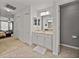 Bright bathroom featuring double vanity with linen storage and neutral decor at 27231 Liriope Ct, Wesley Chapel, FL 33544