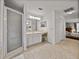Bright bathroom featuring walk-in shower and double vanity with makeup counter at 27231 Liriope Ct, Wesley Chapel, FL 33544
