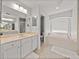 Bright bathroom features double vanity, separate soaking tub with window, and walk-in shower at 27231 Liriope Ct, Wesley Chapel, FL 33544