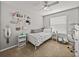 Well-lit bedroom with a ceiling fan and a window view, complete with decor at 27231 Liriope Ct, Wesley Chapel, FL 33544