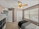 Bedroom featuring a ceiling fan, a closet, and a window, as well as a desk with shelving at 27231 Liriope Ct, Wesley Chapel, FL 33544