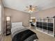 Comfortable bedroom featuring a ceiling fan, a desk with a computer, and decor at 27231 Liriope Ct, Wesley Chapel, FL 33544