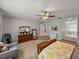 Another angle inside primary bedroom showcasing neutral tones, ceiling fan, and sitting area at 27231 Liriope Ct, Wesley Chapel, FL 33544