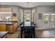 Bright dining area with large windows, table seating, and open to the kitchen at 27231 Liriope Ct, Wesley Chapel, FL 33544