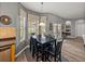 Cozy dining area featuring a table, large windows, and access to outdoor views at 27231 Liriope Ct, Wesley Chapel, FL 33544