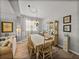 Traditional dining room features a wooden table, hutch, and decorative chandelier at 27231 Liriope Ct, Wesley Chapel, FL 33544