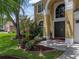 Charming two-story home featuring lush landscaping and a well-maintained lawn at 27231 Liriope Ct, Wesley Chapel, FL 33544