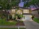 Charming two-story home featuring lush landscaping and a well-maintained front yard at 27231 Liriope Ct, Wesley Chapel, FL 33544