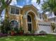 Well-maintained two-story home with mature trees and a neatly manicured lawn at 27231 Liriope Ct, Wesley Chapel, FL 33544