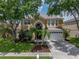 Charming two-story home featuring lush landscaping and a well-maintained front yard at 27231 Liriope Ct, Wesley Chapel, FL 33544