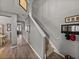 Inviting hallway featuring a staircase, neutral paint, and seamless flooring at 27231 Liriope Ct, Wesley Chapel, FL 33544